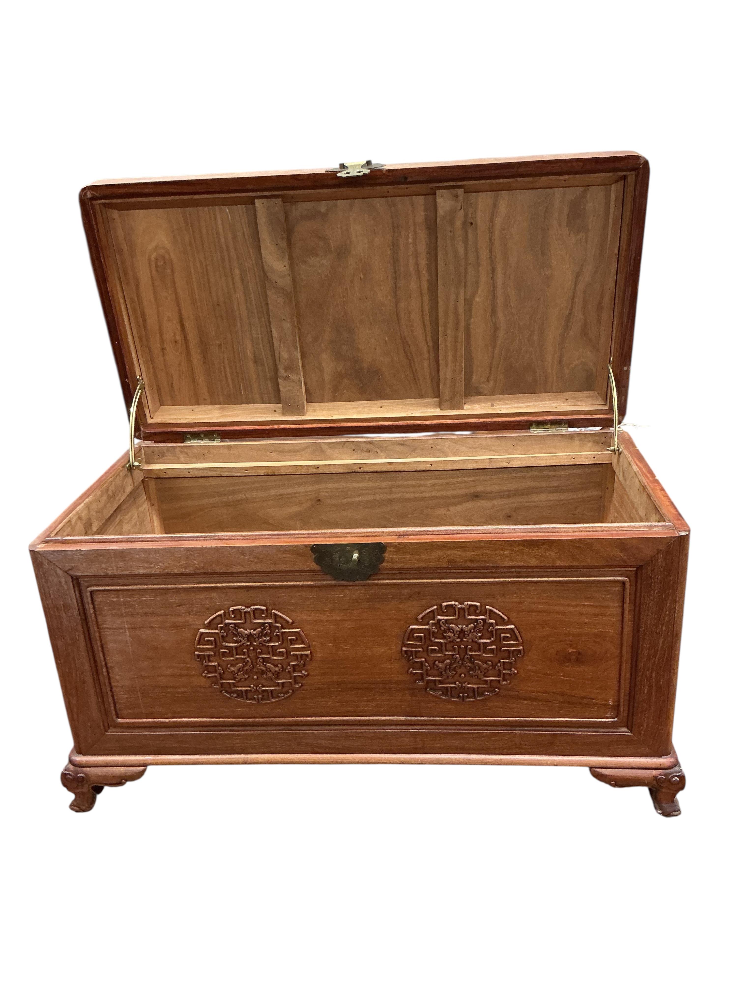 A Chinese carved camphor wood trunk, width 100cm, depth 54cm, height 59cm